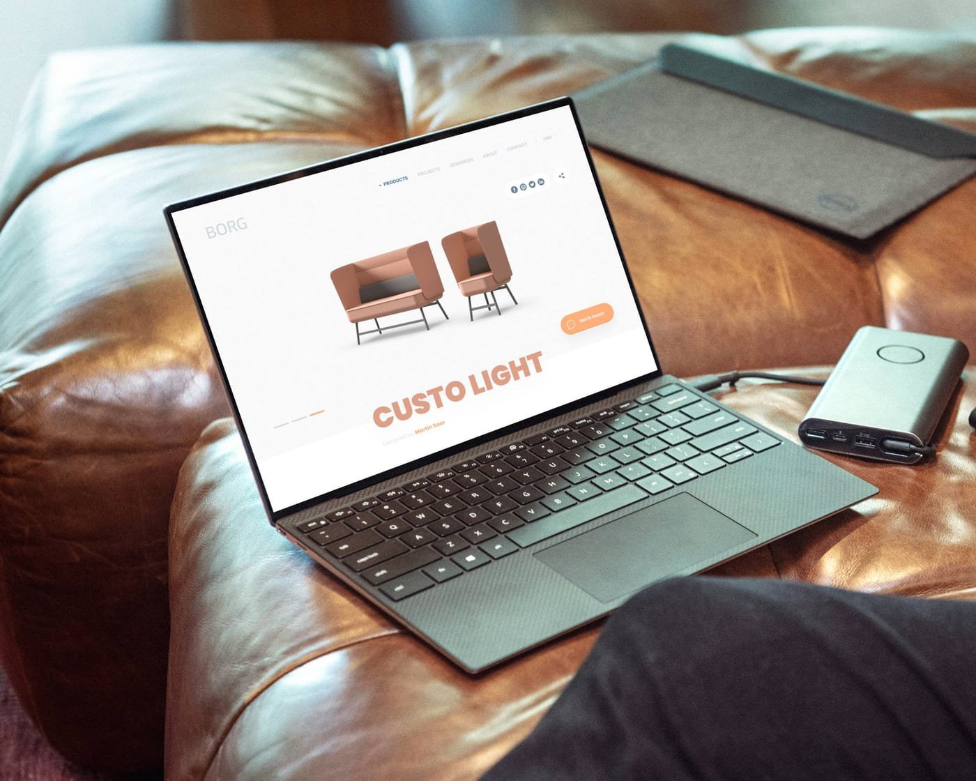 Borg website hero on a laptop resting on a leather couch
