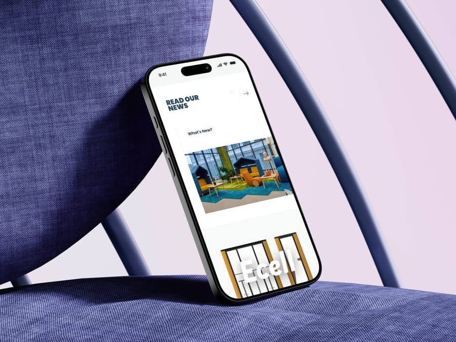Borg news page on a phone leaning against a blue chair